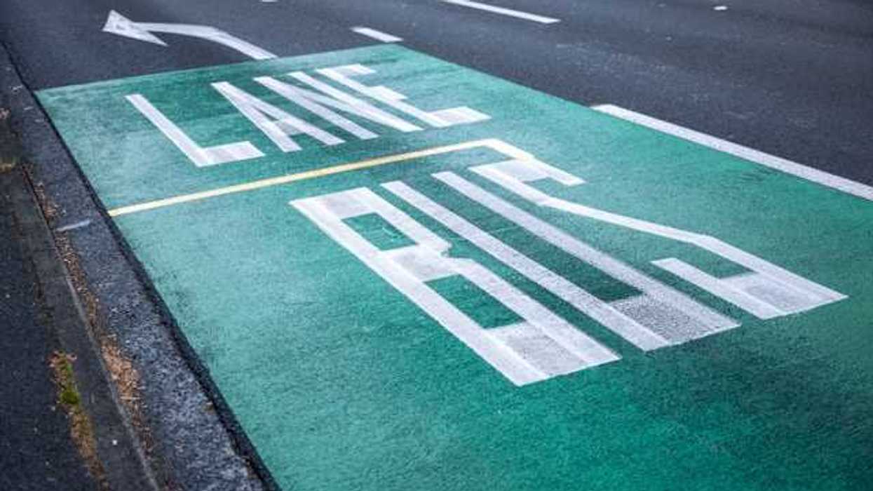 A street with the words Bus Lane painted in one lane