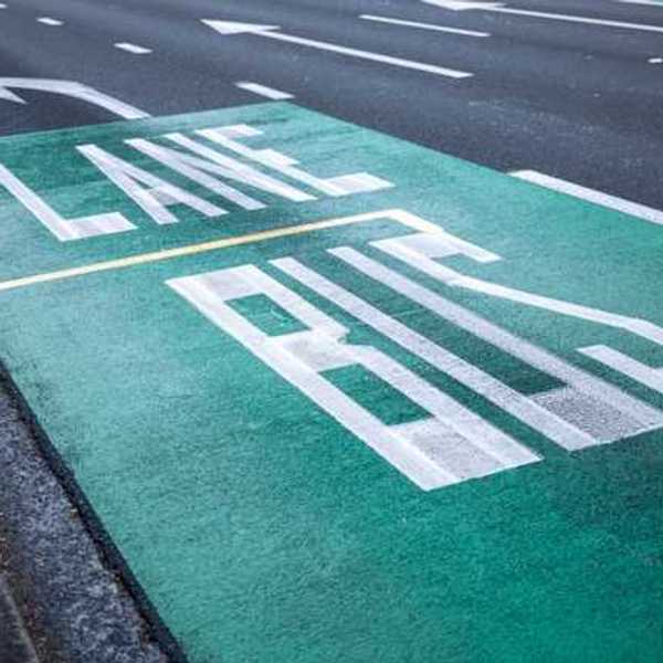 A street with the words Bus Lane painted in one lane