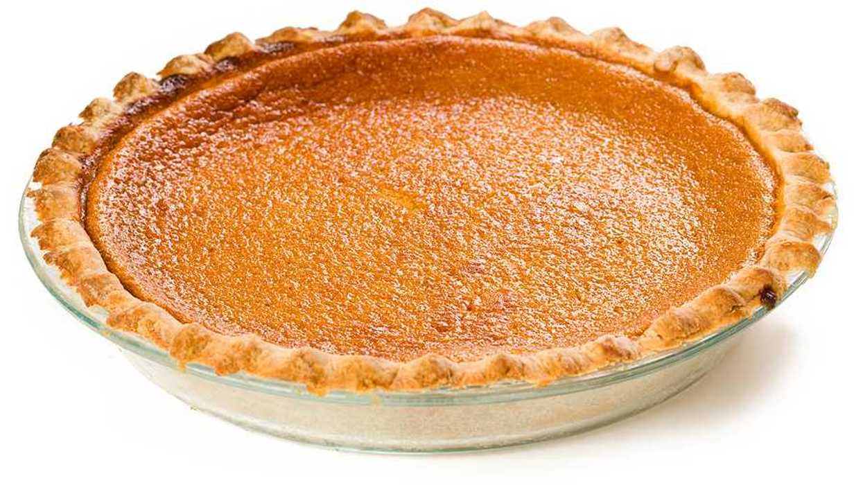 A sweet potato pie sitting on a white surface