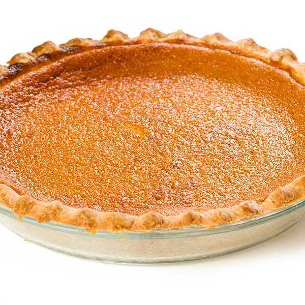 A sweet potato pie sitting on a white surface