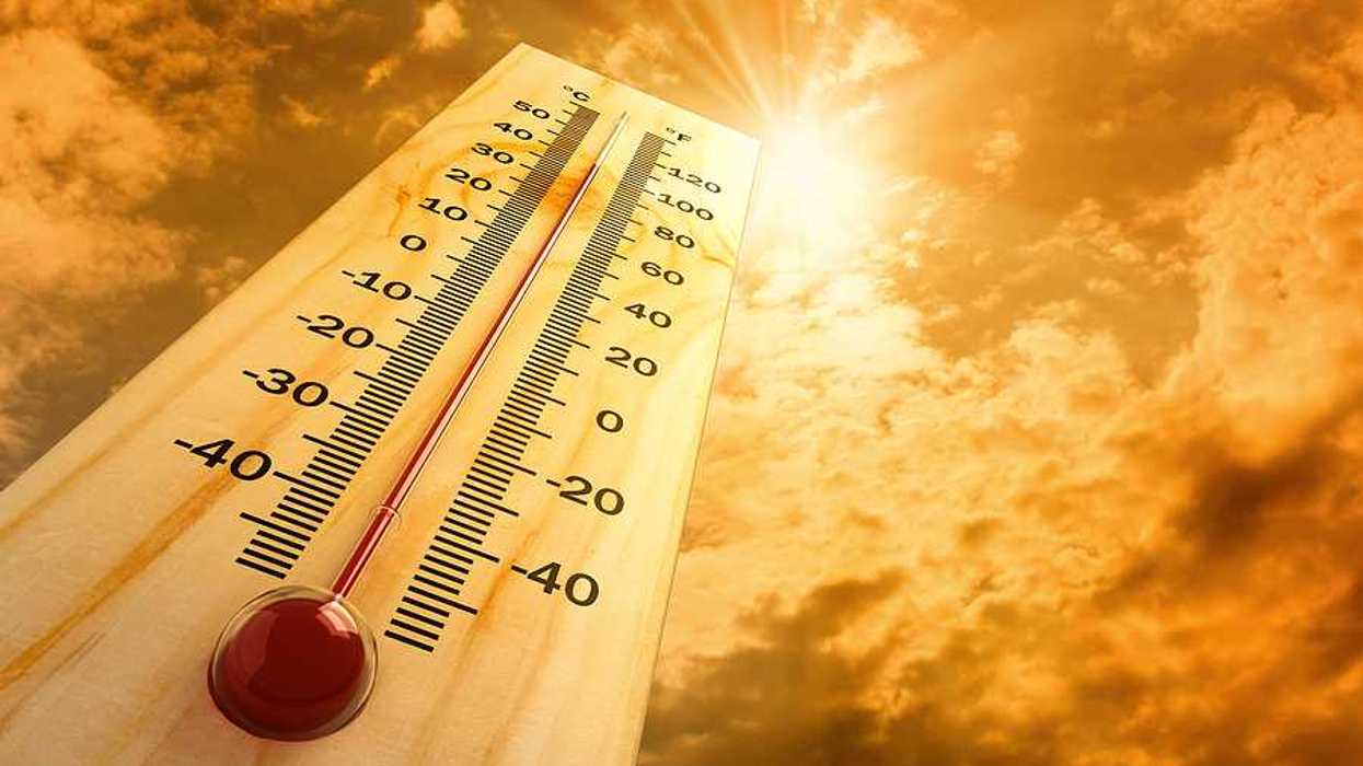 A thermometer pointing skyward towards a searing sun