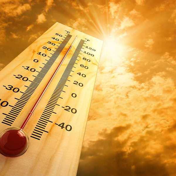 A thermometer pointing skyward towards a searing sun