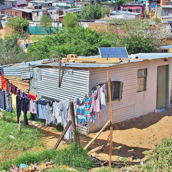 A tin hut with a small solar panel on the roof