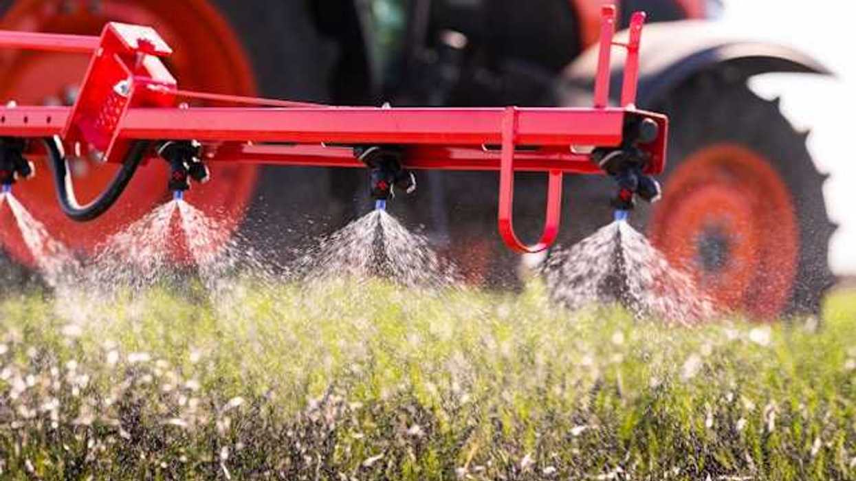 A tractor applying pesticides