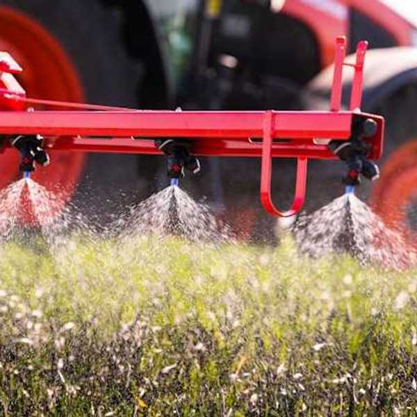 A tractor applying pesticides