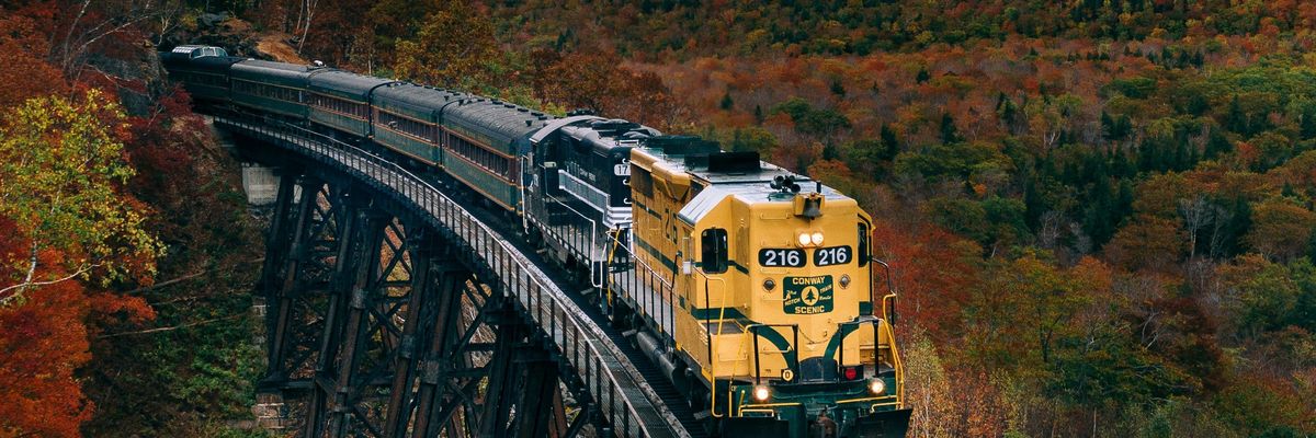 A train travels through a fall landscape
