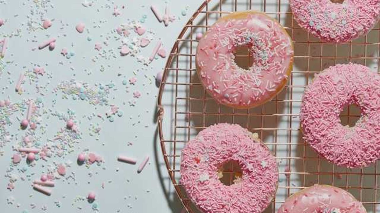 A tray of pink donuts