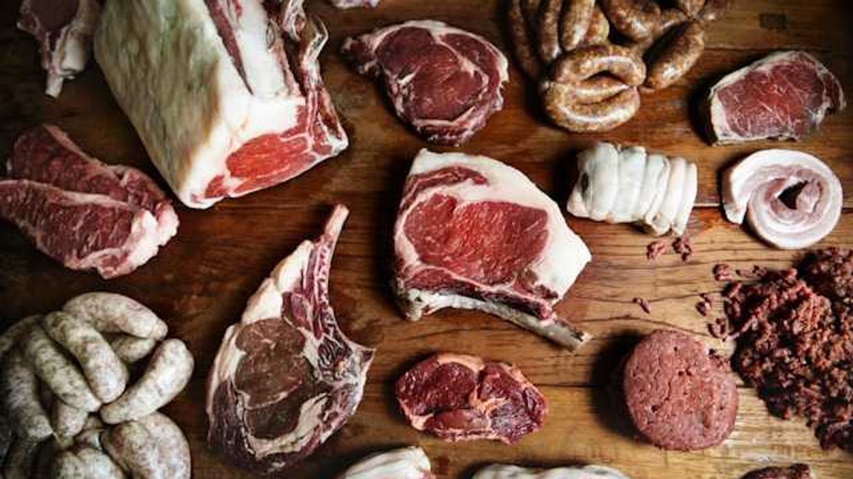 A variety of meat arranged on a wooden surface