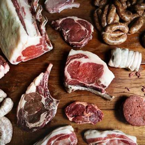 A variety of meat arranged on a wooden surface