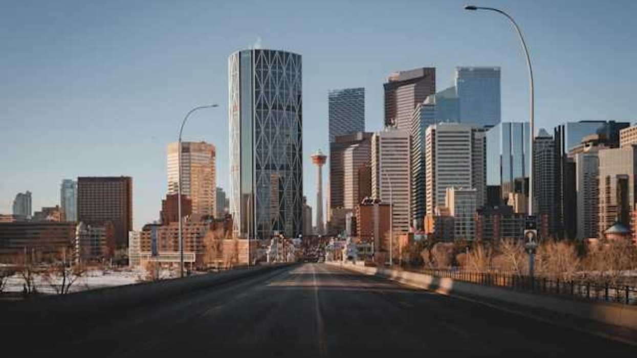 A view down a highway at the skyline of Toronto Canada