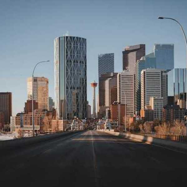 A view down a highway at the skyline of Toronto Canada