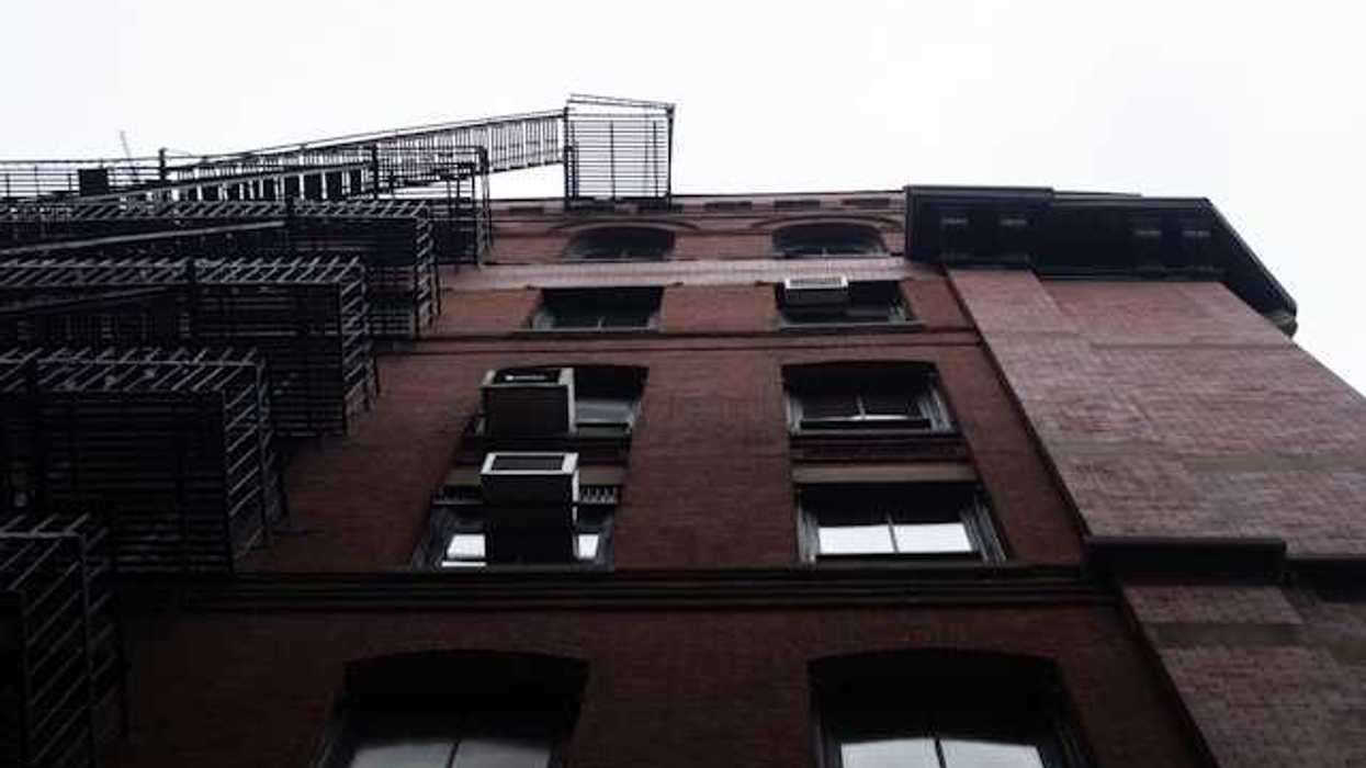 A view from below of a brick apartment building