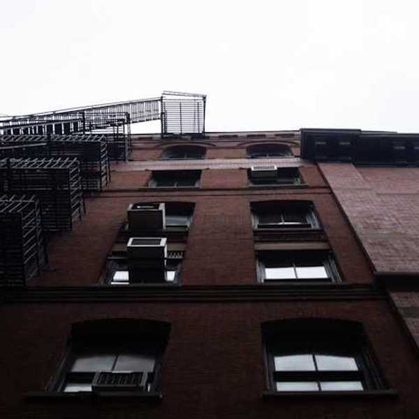 A view from below of a brick apartment building