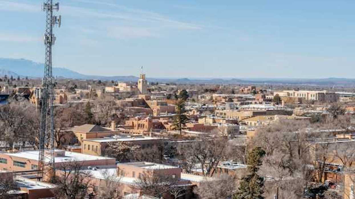 A view of a city with a cell tower in the foreground