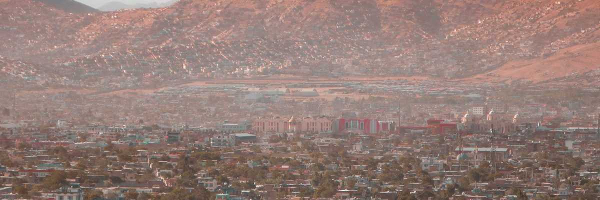 a view of a city with dry mountains in the background.
