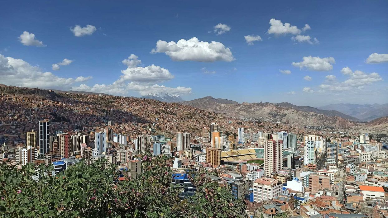 a view of a city with mountains in the background.