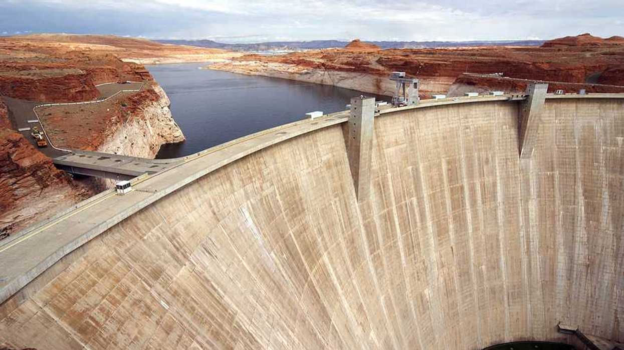 A view of a dam with a reservoir in the background