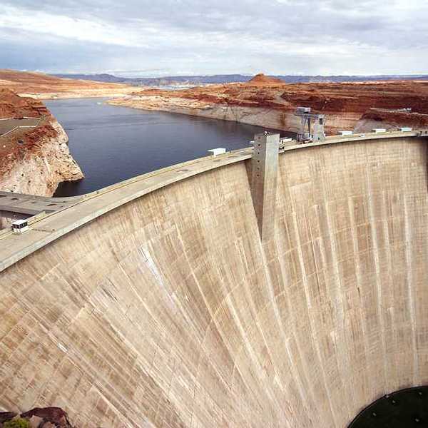 A view of a dam with a reservoir in the background