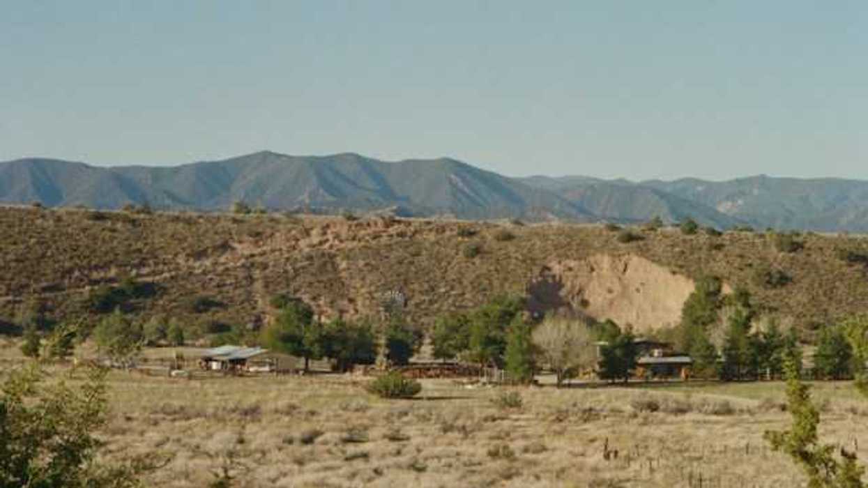 A view of a dry desert environment with hills in the background