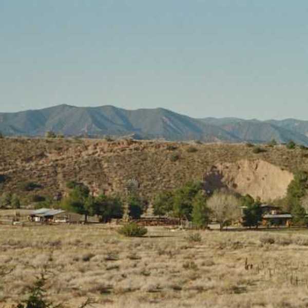 A view of a dry desert environment with hills in the background