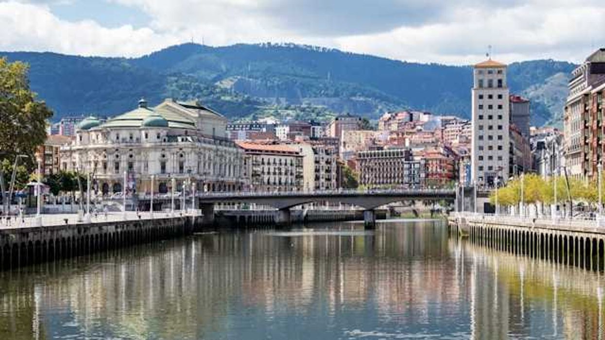 A view of a European town with a river and bridge