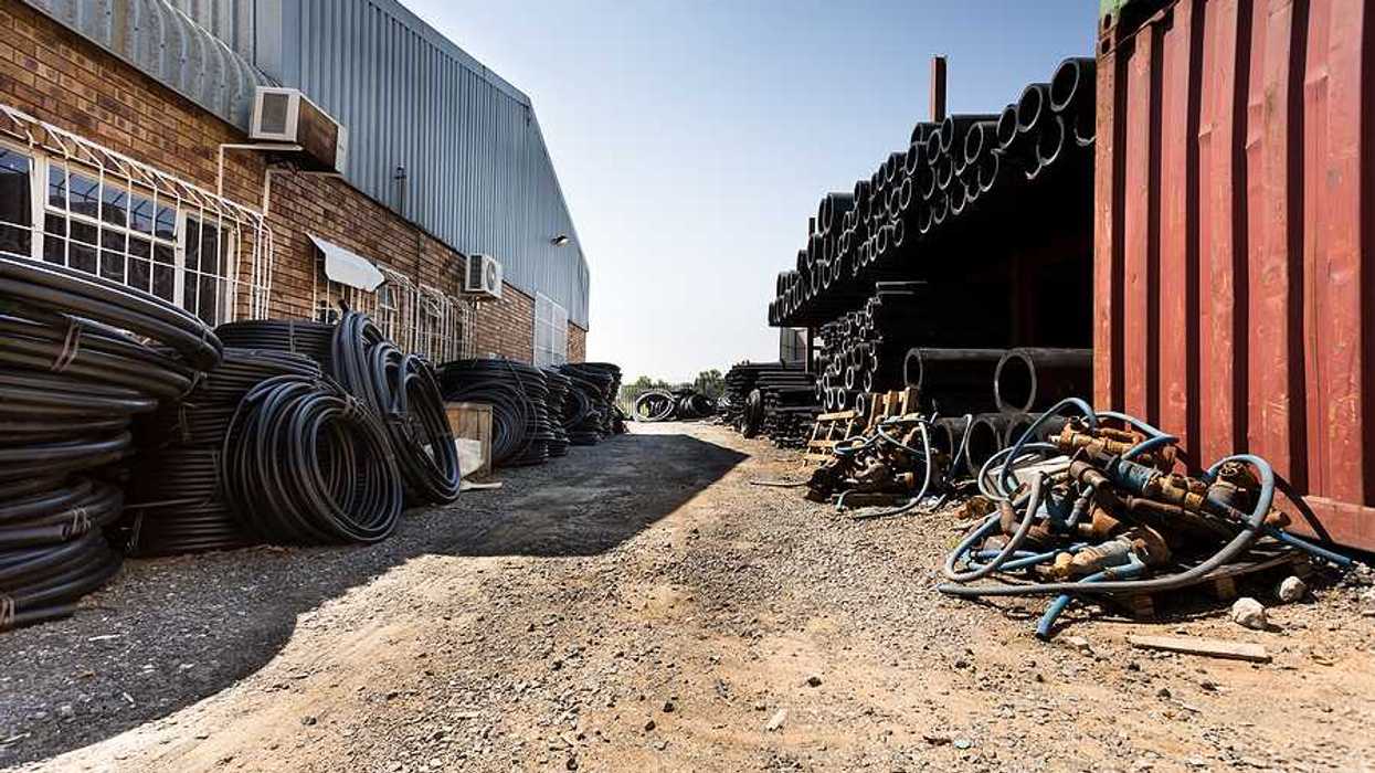 A view of a factory with brick and metal buildings