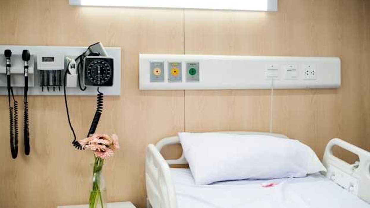 A view of a hospital bed with associated equipment next to it