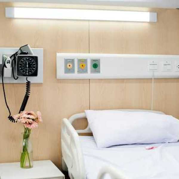 A view of a hospital bed with associated equipment next to it