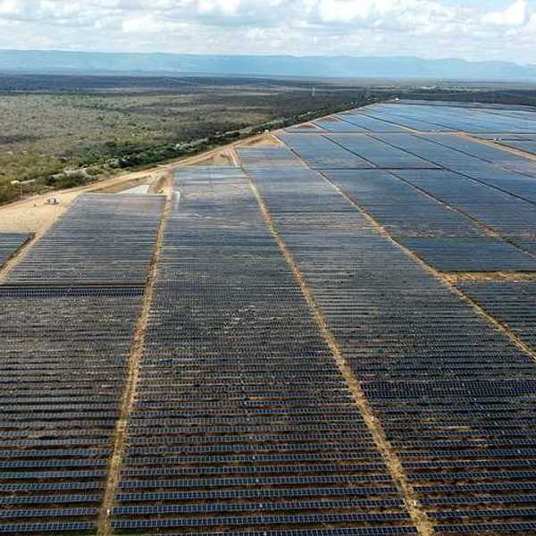 A view of a huge solar farm in Brazil with mountain ranges in the background