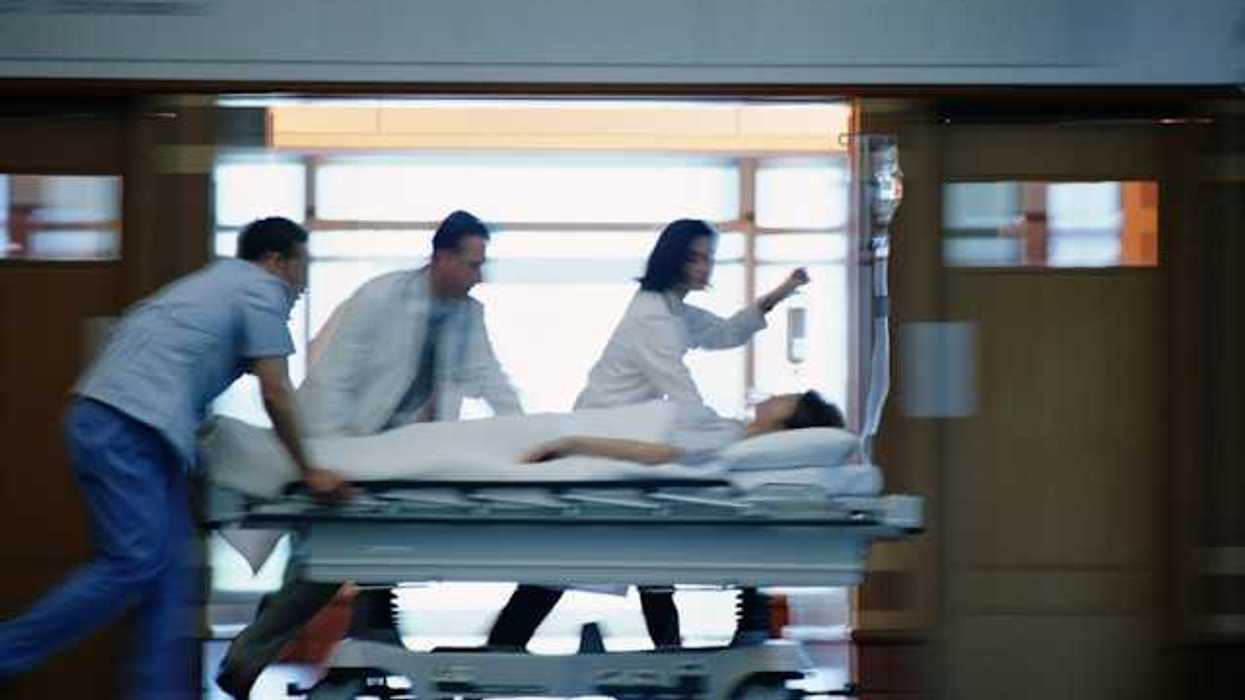 A view of a patient on a gurney being rushed through a hospital