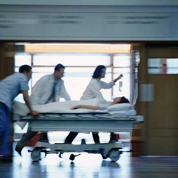 A view of a patient on a gurney being rushed through a hospital