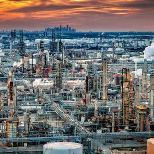 A view of a petrochemical plant with a skyline in the background