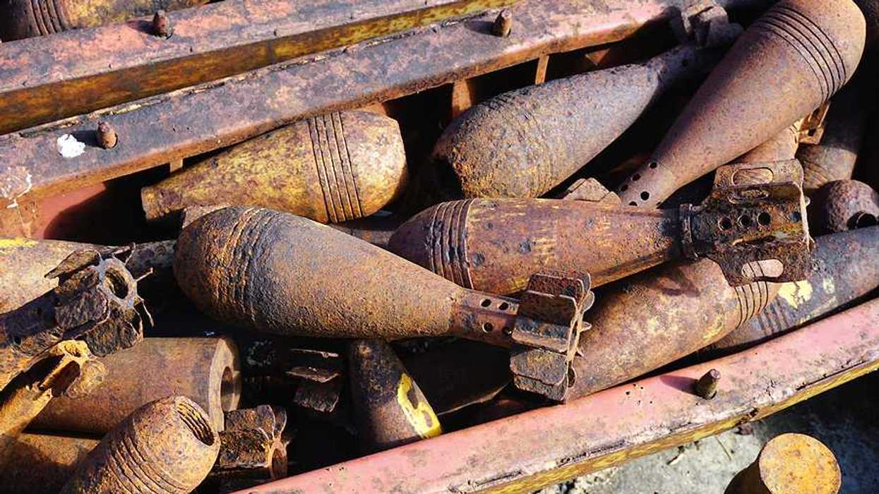 A view of a pile of rusty old military munitions and unexploded bombs