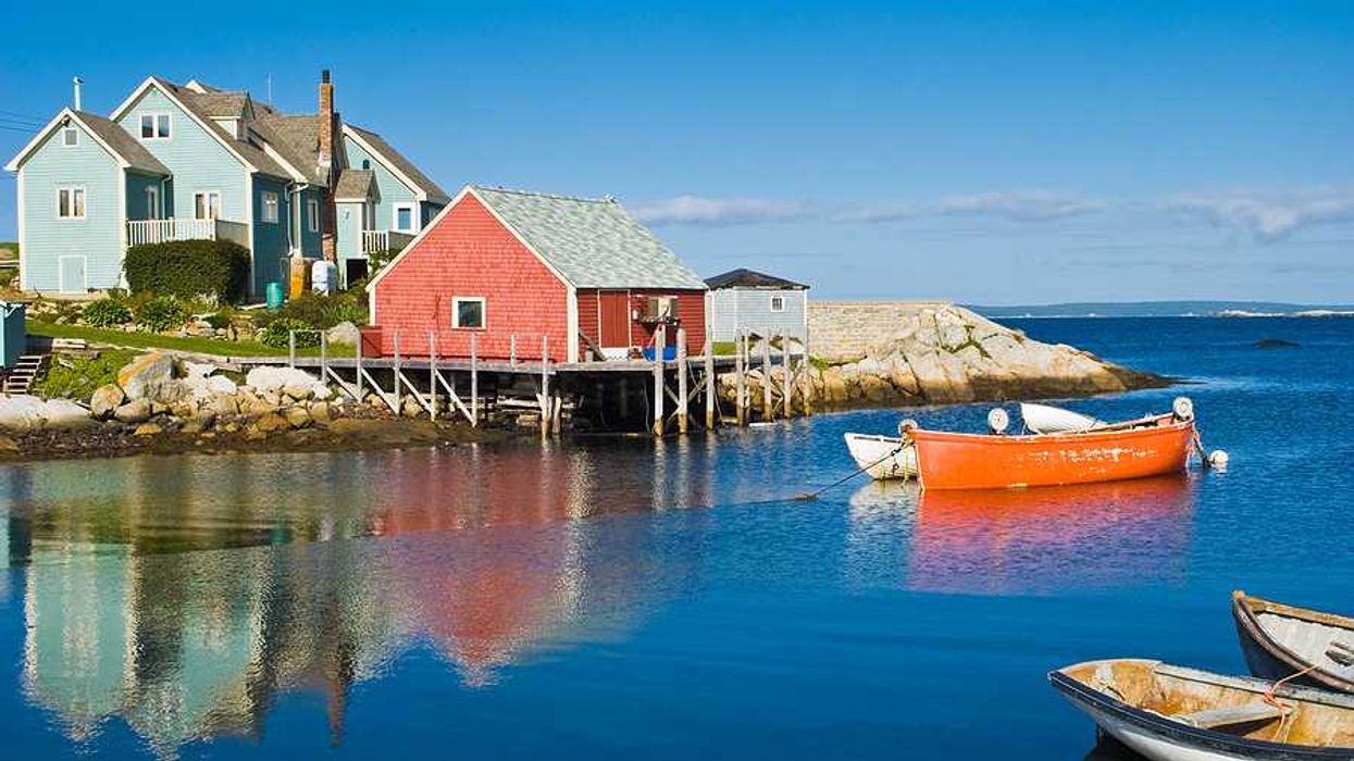 A view of a red fisherman's hut on the water in Nova Scotia