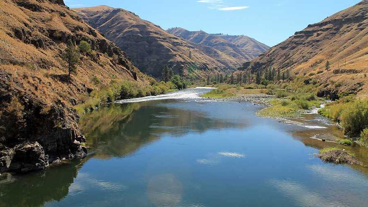 A view of a river flowing in a treeless valley