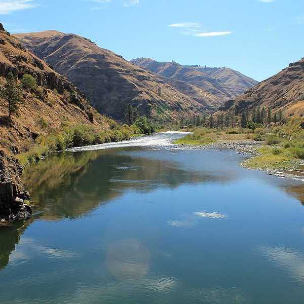 A view of a river flowing in a treeless valley