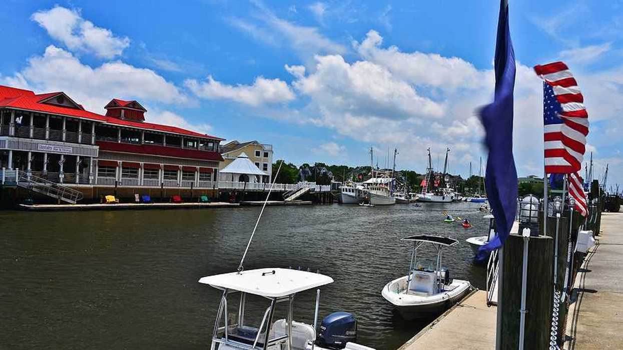 A view of a river with a dock and boats alongside