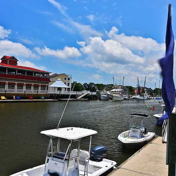 A view of a river with a dock and boats alongside