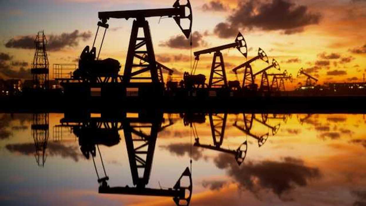 A view of a row of oil pump jacks at sunset