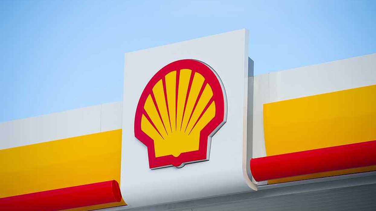 A view of a sign with the Shell Oil logo on it in red and yellow in the shape of a shell