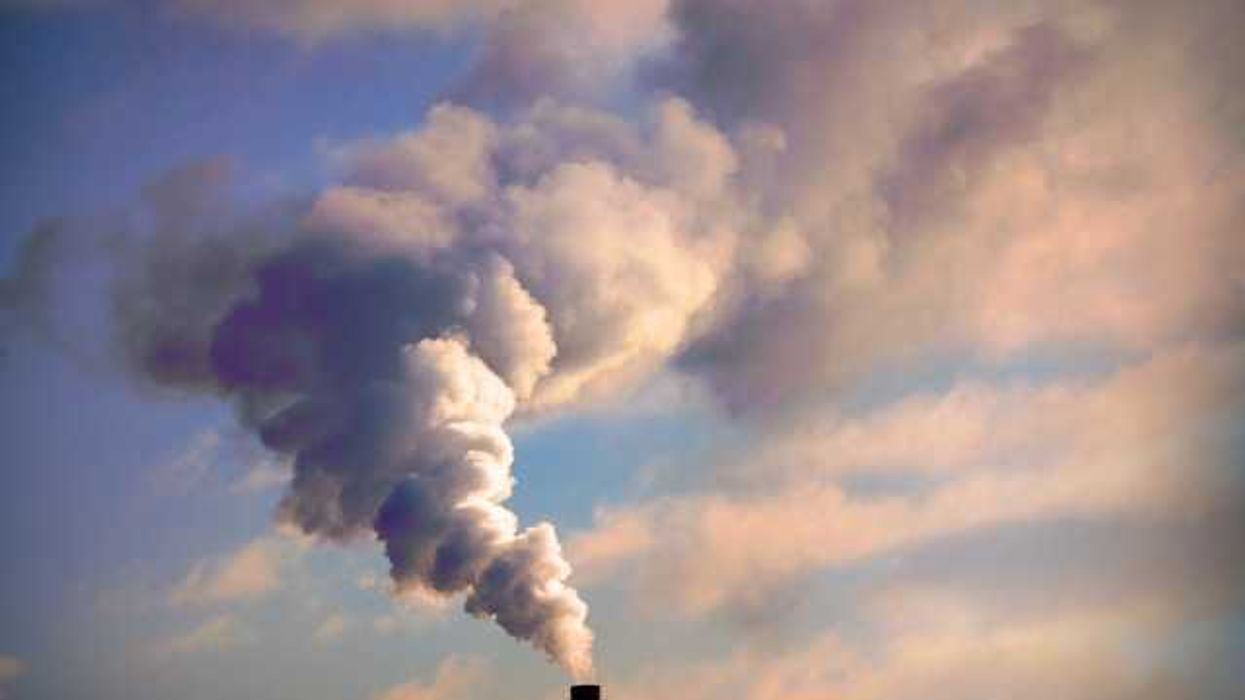 A view of a smokestack with billowing smoke