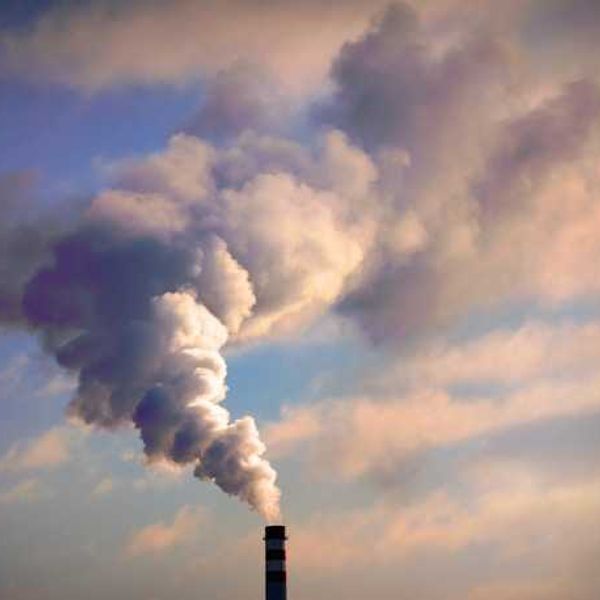 A view of a smokestack with billowing smoke