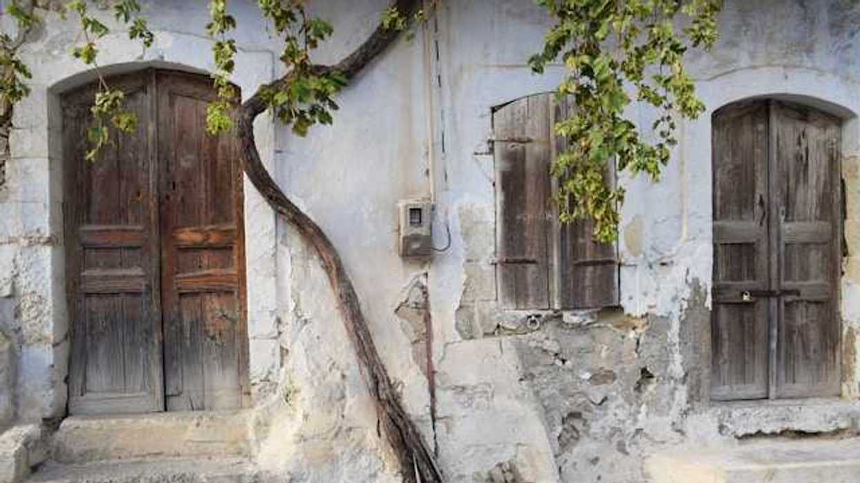 A view of a street with houses with cracked facades