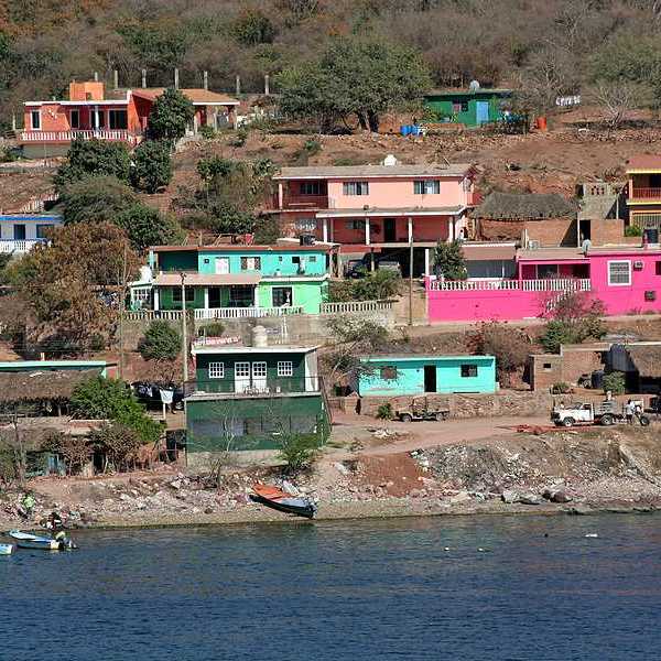 A view of a village on hills above the ocean