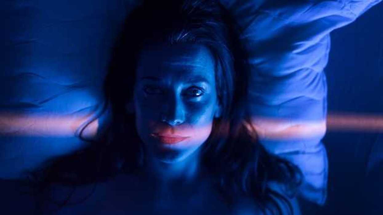 A view of a woman awake in bed