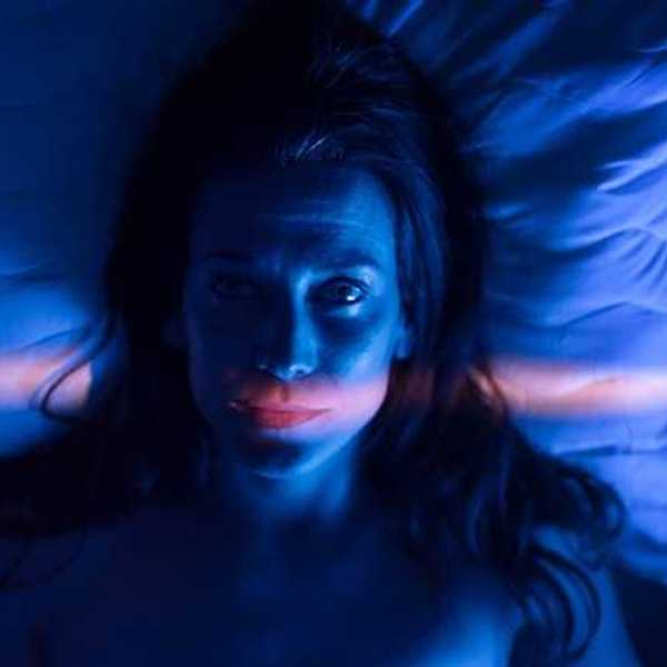 A view of a woman awake in bed