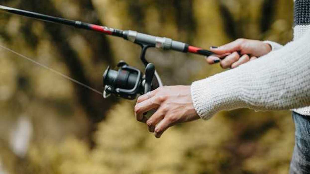 A view of a woman's hands with a fishing pole