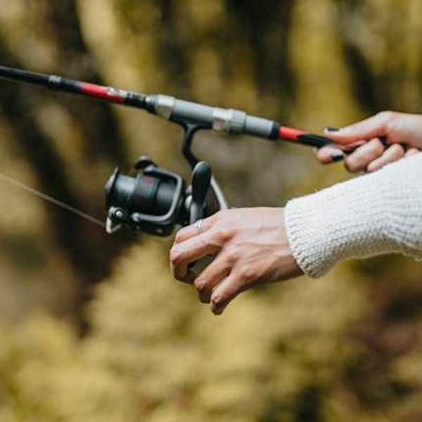 A view of a woman's hands with a fishing pole