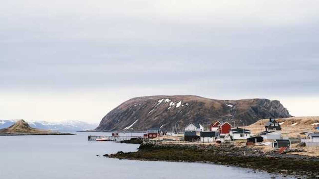 A view of an Alaskan village on the edge of a body of water