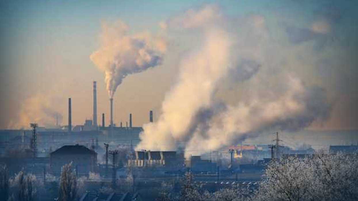 A view of an industrial area with pollution pouring from smokestacks